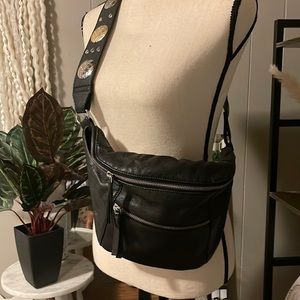 Free People black leather with large conches cross body bag.